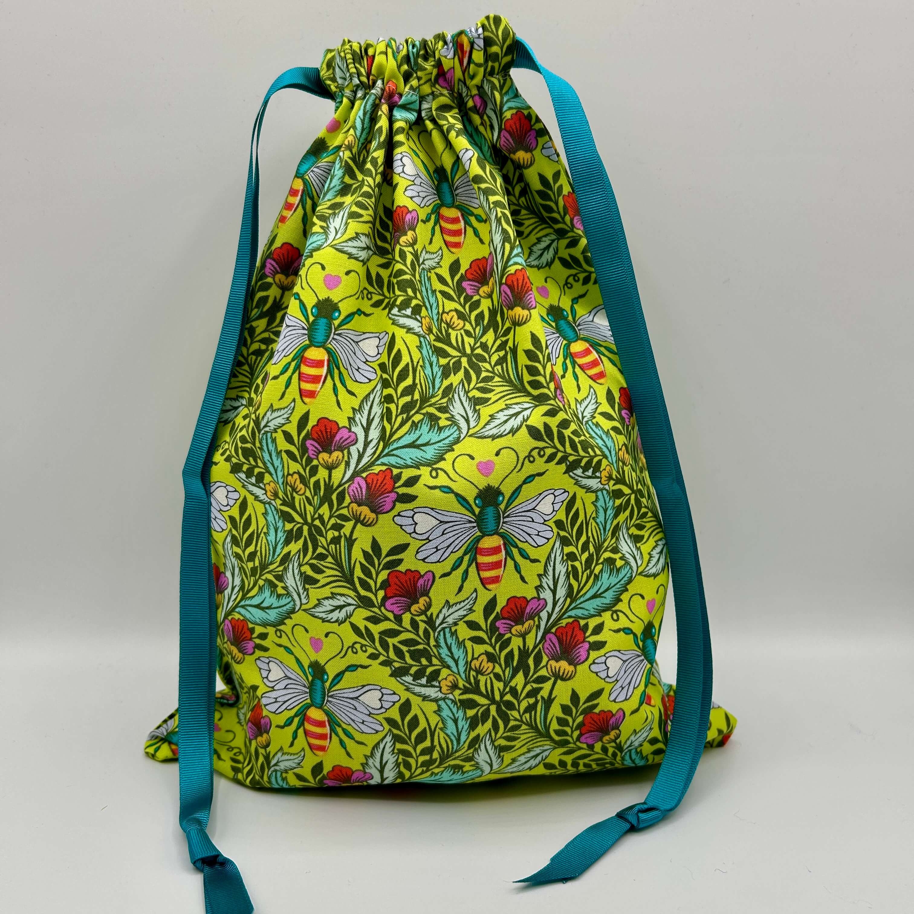 Drawstring bag with butterfly and floral pattern on a white background