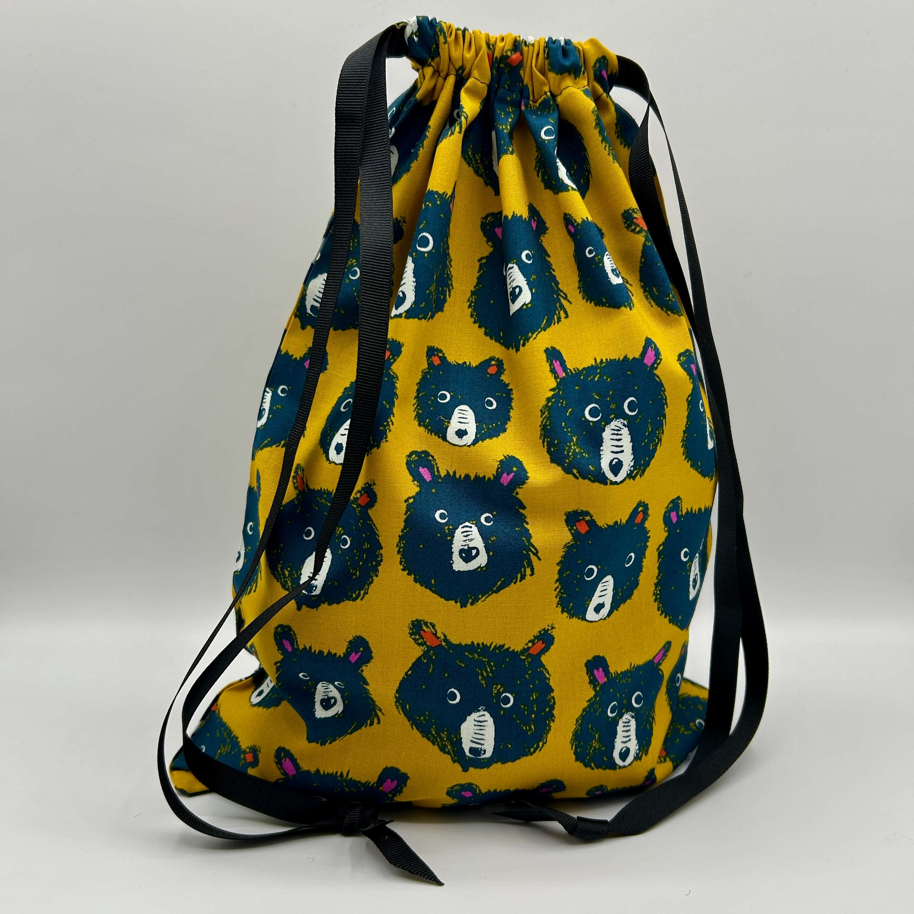 Drawstring bag with bear pattern on a yellow background