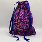 Drawstring bag with purple and blue pattern on a light gray background