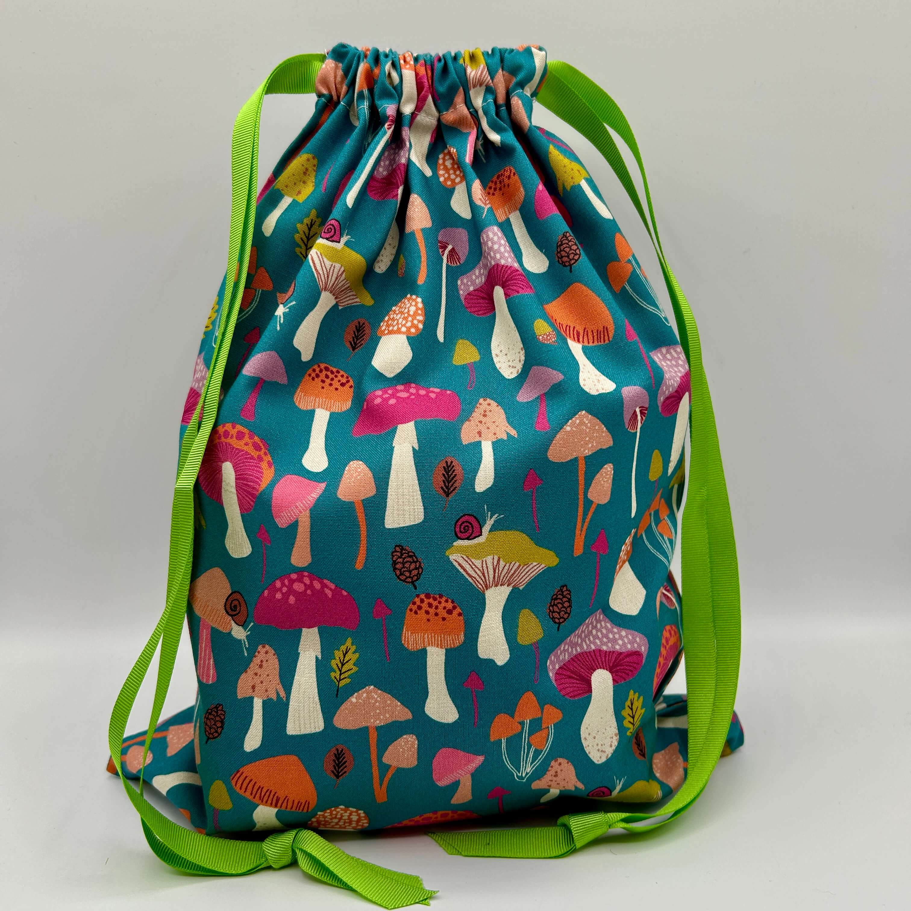 Drawstring bag with colorful mushroom pattern on a blue background